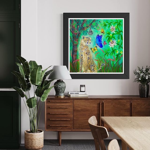 Painting of a cheetah and a butterfly on a green background. Famed and in situ